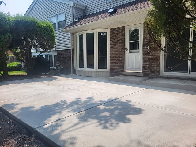 Large concrete patio pour at brick ranch home