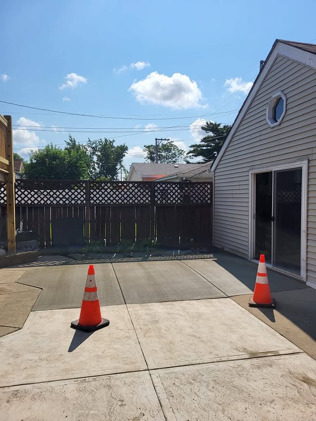 Fresh concrete pad replacement near garage